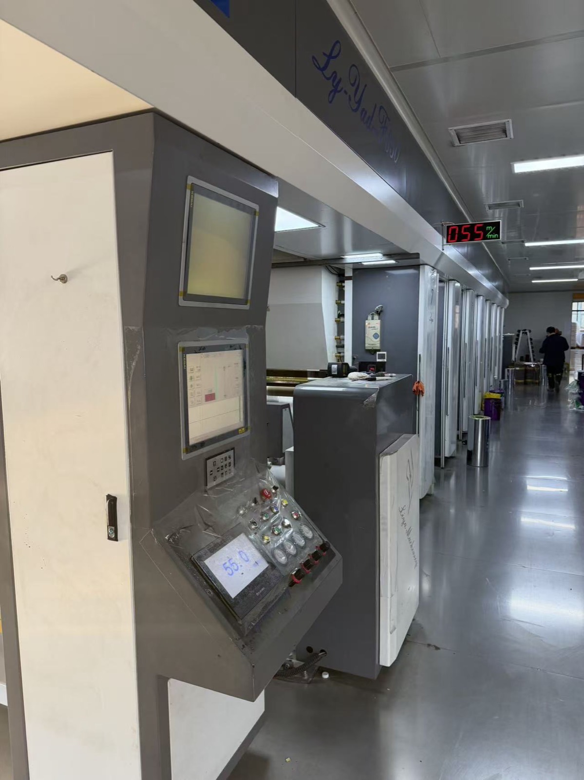 Printing line running with overhead display reading 055 metres per minute