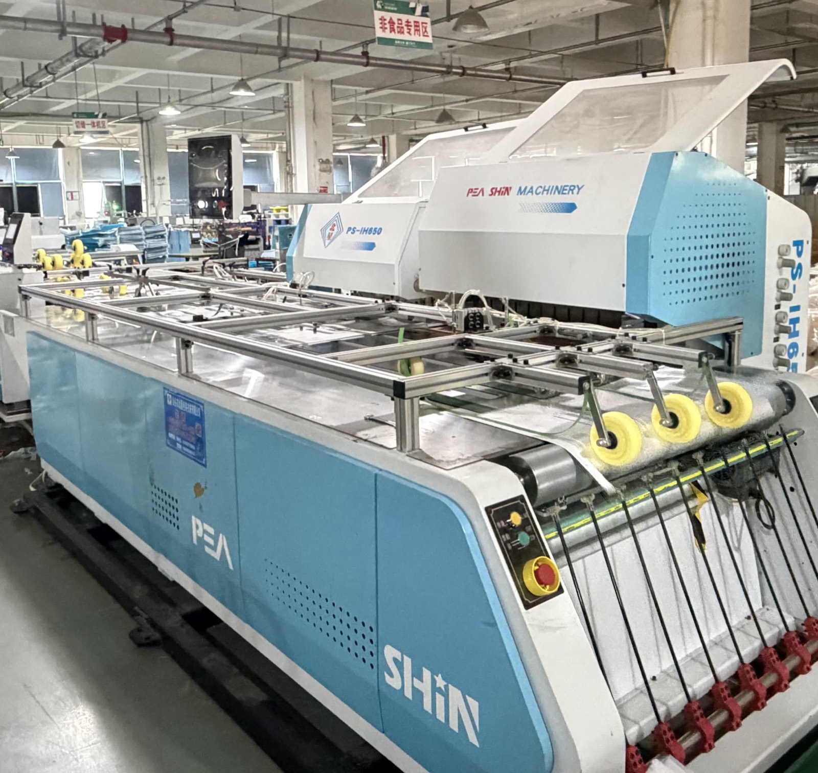 Bag-making machine with guarded transfer table and drive rollers
