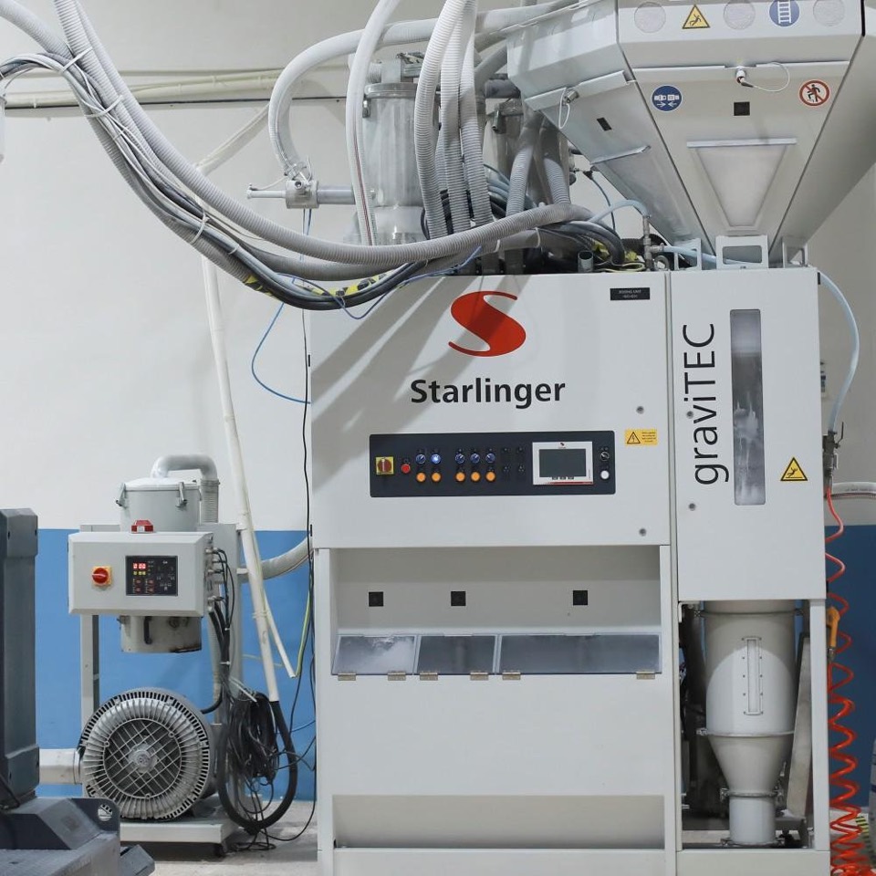 Starlinger graviTEC gravimetric dosing unit with control panel, feed hoses and a side-channel blower